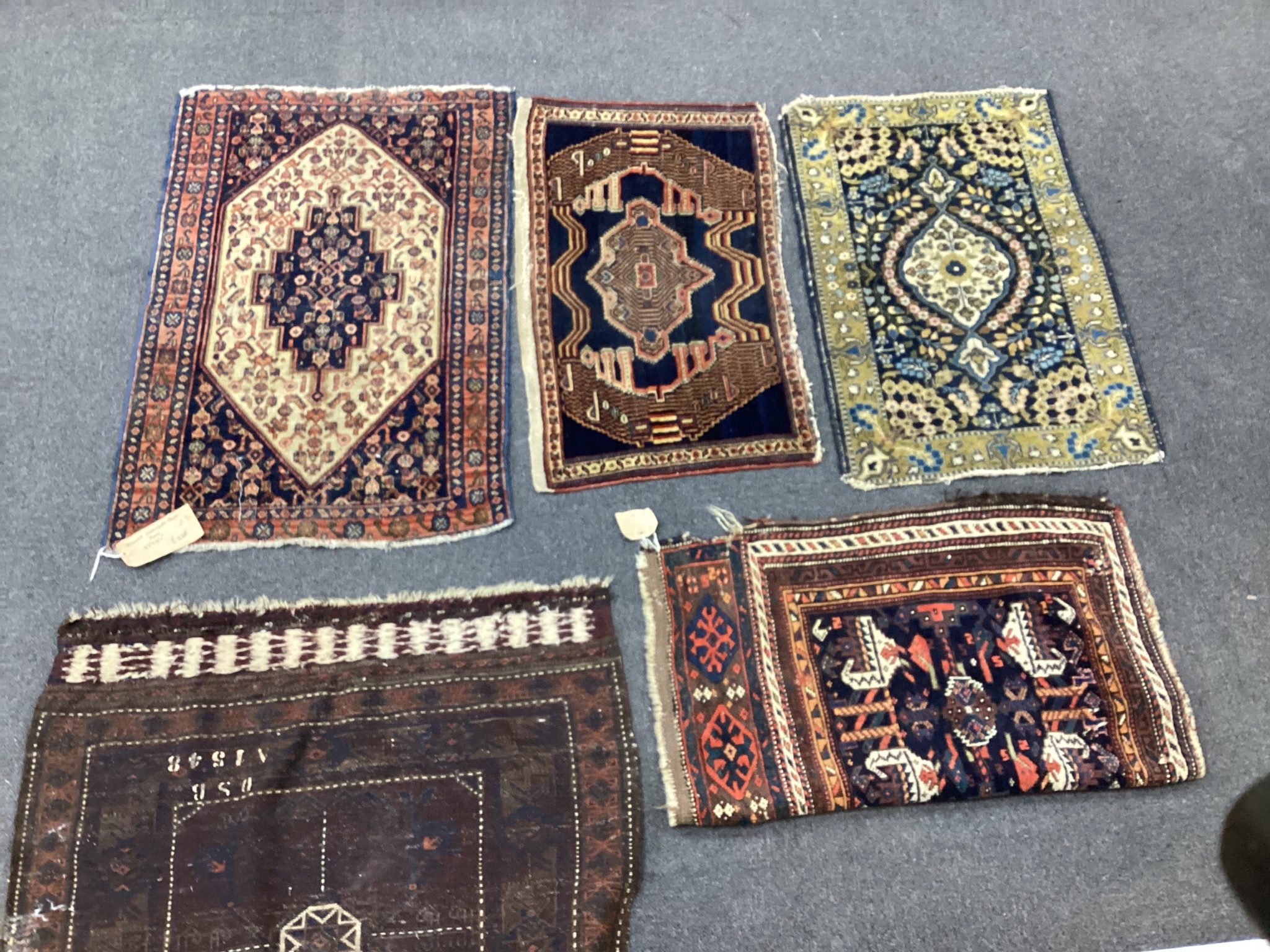An antique Hamadan mat, a Kurdish mat and three others, largest 92cms x 60cms.